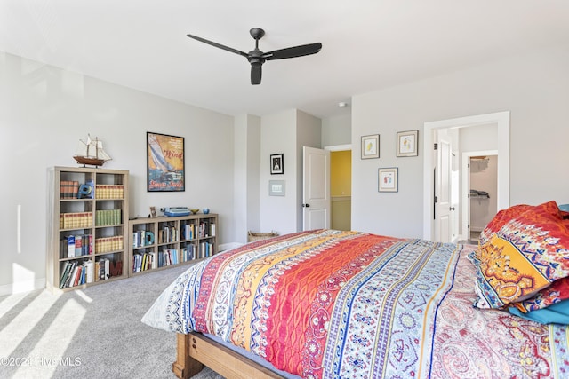 carpeted bedroom with connected bathroom and ceiling fan