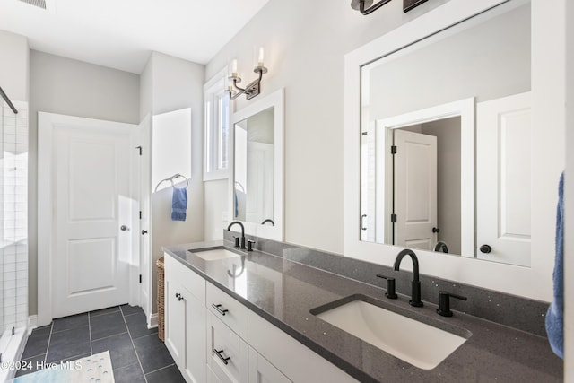 bathroom featuring tile patterned flooring, vanity, and a chandelier