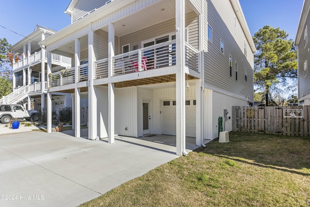 rear view of house with a lawn and a garage