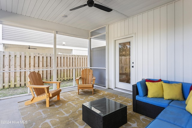 sunroom / solarium featuring ceiling fan