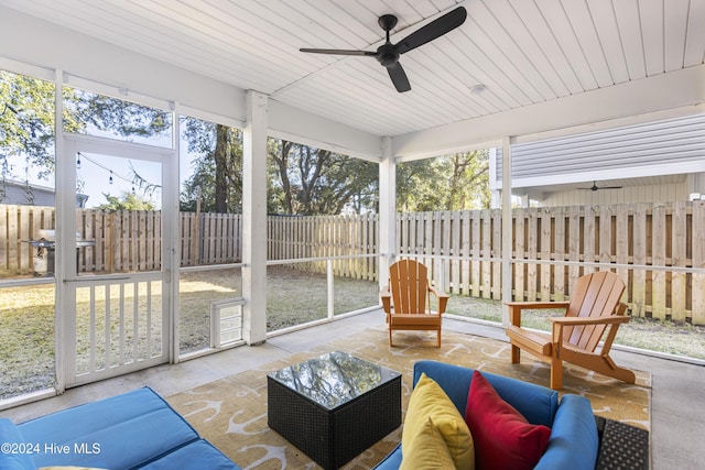 sunroom featuring ceiling fan and wooden ceiling