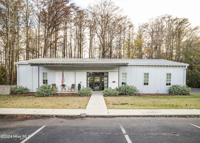 view of front of property with covered porch and a front yard