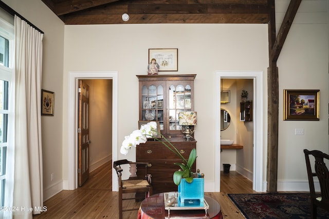 interior space featuring hardwood / wood-style floors and lofted ceiling with beams