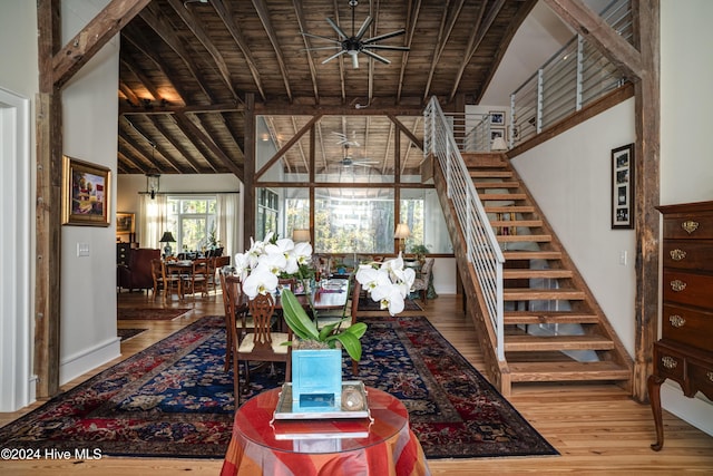 living room featuring hardwood / wood-style floors, ceiling fan, wood ceiling, and beamed ceiling