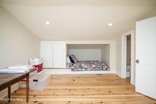 bedroom with light hardwood / wood-style flooring and vaulted ceiling