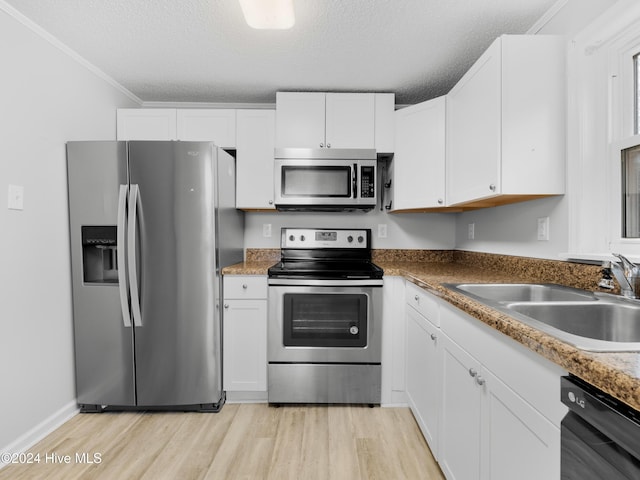 kitchen with white cabinets, sink, a textured ceiling, and appliances with stainless steel finishes