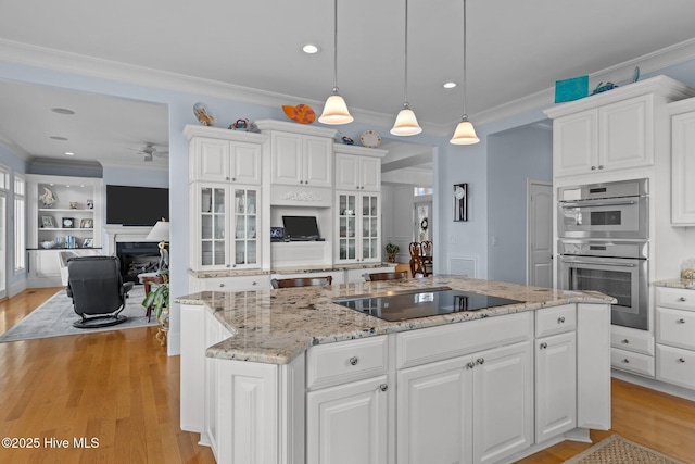 kitchen featuring pendant lighting, white cabinetry, black electric stovetop, and stainless steel double oven