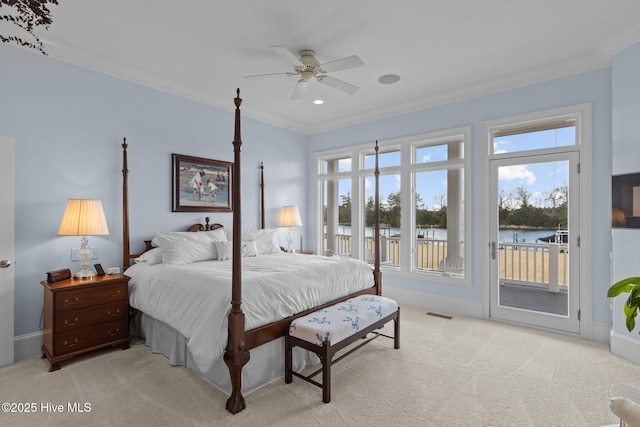 carpeted bedroom featuring ceiling fan, crown molding, a water view, and access to outside