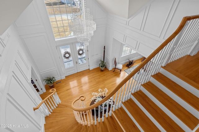 entryway featuring a notable chandelier, a high ceiling, and hardwood / wood-style floors