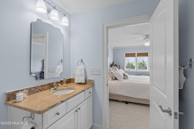 bathroom with ceiling fan, crown molding, and vanity