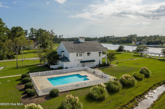 exterior space with a water view, a yard, a patio, and a fenced in pool