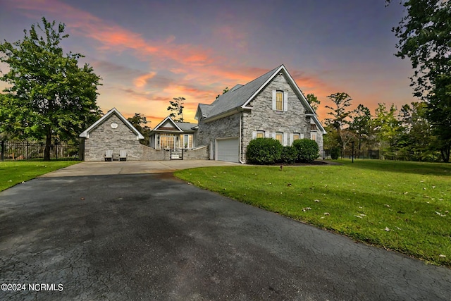 view of front of house featuring a yard and a garage