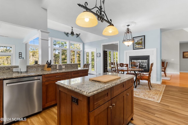 kitchen with pendant lighting, dishwasher, a healthy amount of sunlight, and light hardwood / wood-style floors