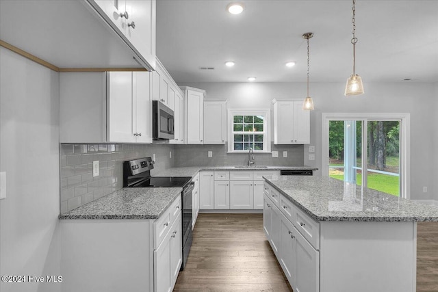 kitchen with a center island, white cabinets, sink, black / electric stove, and dark hardwood / wood-style flooring