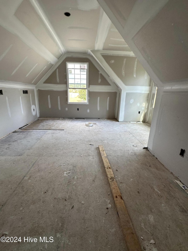 additional living space featuring vaulted ceiling