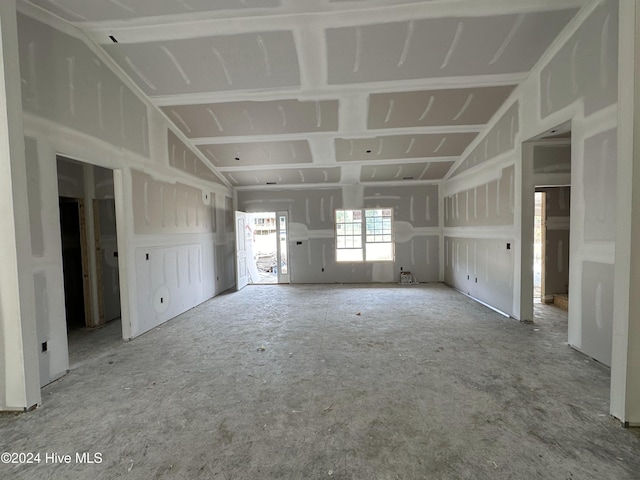 unfurnished room featuring lofted ceiling