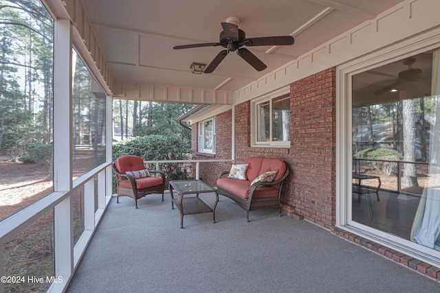 sunroom / solarium featuring ceiling fan