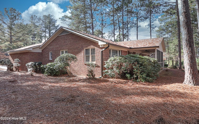 view of property exterior featuring a sunroom