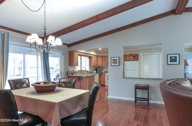 dining room featuring a chandelier, vaulted ceiling with beams, dark wood-type flooring, and sink