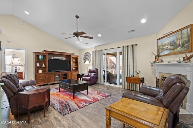 living room with hardwood / wood-style floors, ceiling fan, and vaulted ceiling