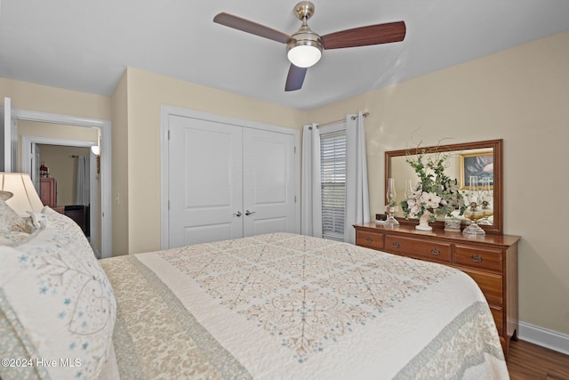 bedroom with a closet, ceiling fan, and dark hardwood / wood-style flooring