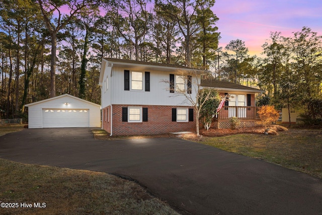 tri-level home with a garage and an outdoor structure