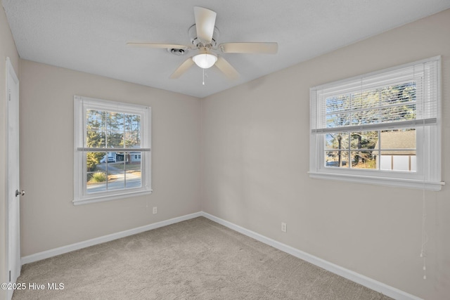 carpeted empty room with ceiling fan