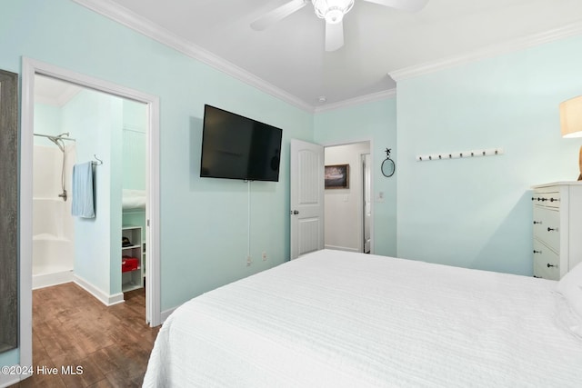 bedroom featuring ensuite bathroom, crown molding, ceiling fan, a spacious closet, and dark hardwood / wood-style flooring