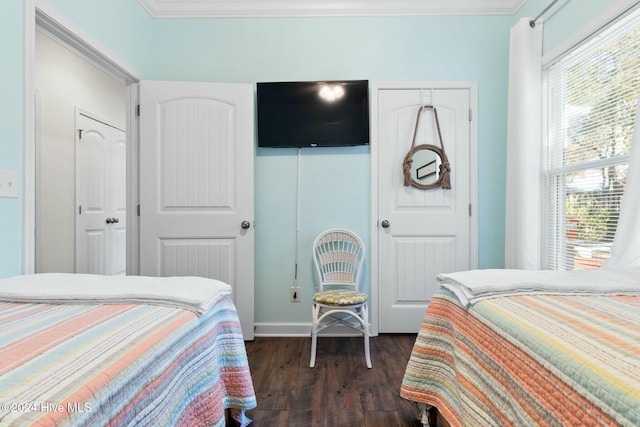 bedroom featuring crown molding and dark wood-type flooring