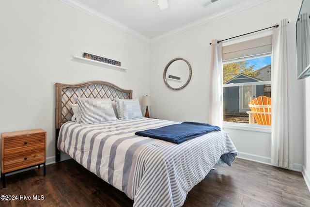 bedroom featuring ceiling fan, crown molding, and dark wood-type flooring