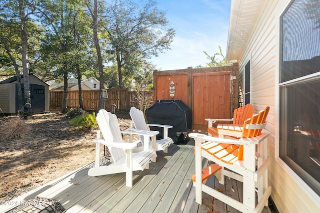 wooden deck with grilling area and a storage unit