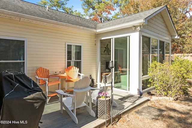 wooden terrace featuring area for grilling and a sunroom