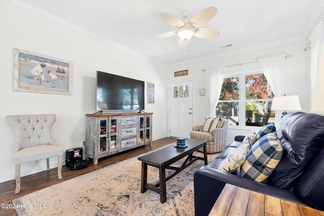 living room with hardwood / wood-style floors, ceiling fan, and crown molding