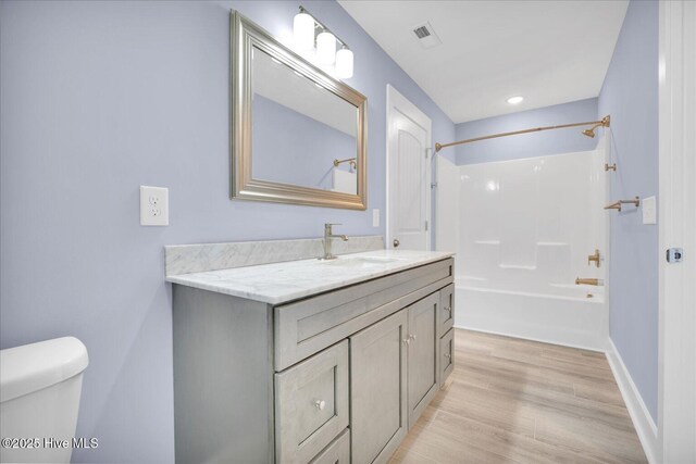 bathroom featuring shower / bathing tub combination and hardwood / wood-style flooring