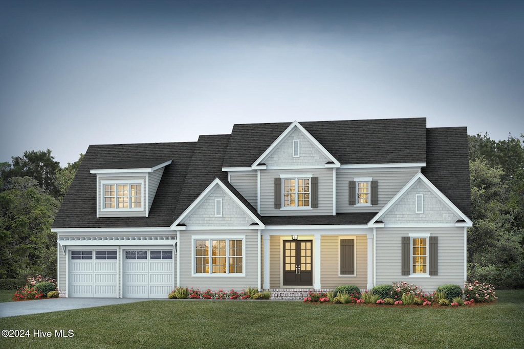 view of front of house with a front lawn, a porch, and a garage