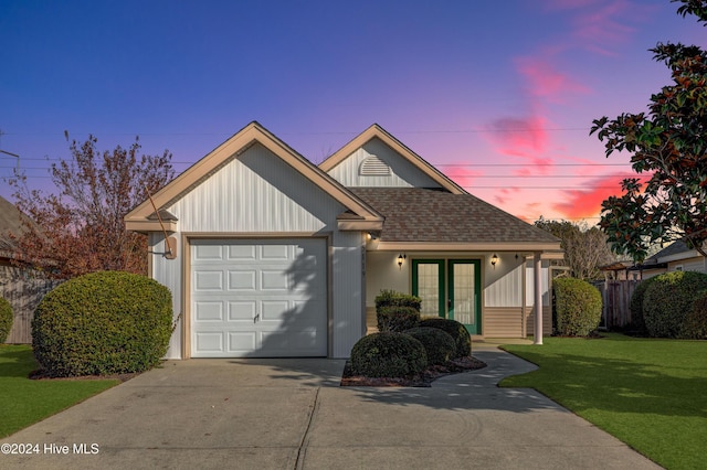 view of front of home with a garage and a yard