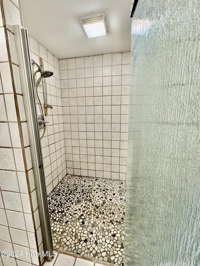 bathroom featuring a shower with shower door