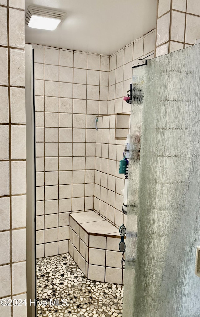 bathroom with a tile shower