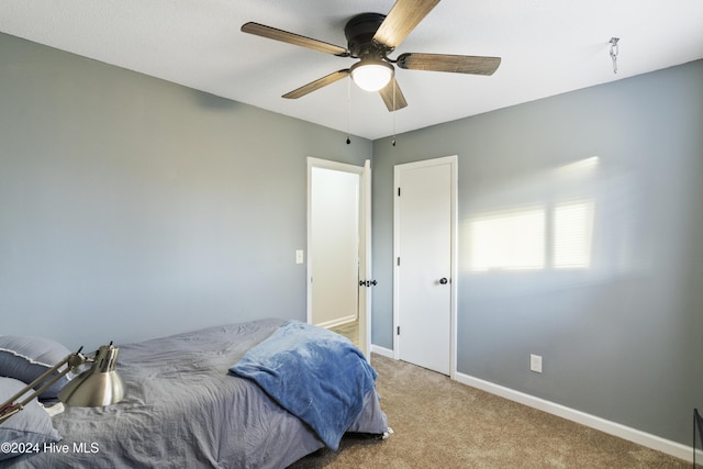 bedroom with ceiling fan and light colored carpet