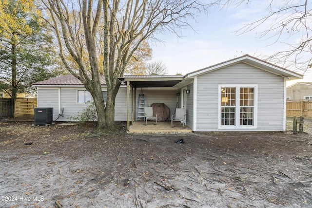 rear view of house with central AC unit