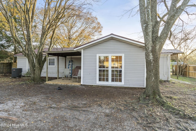 back of property featuring a patio area and cooling unit