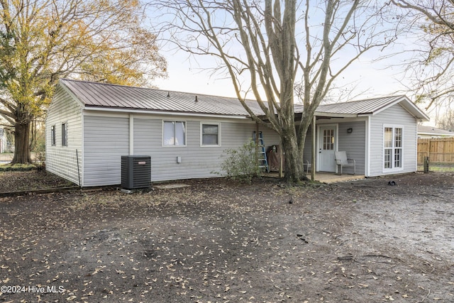 back of house with central air condition unit