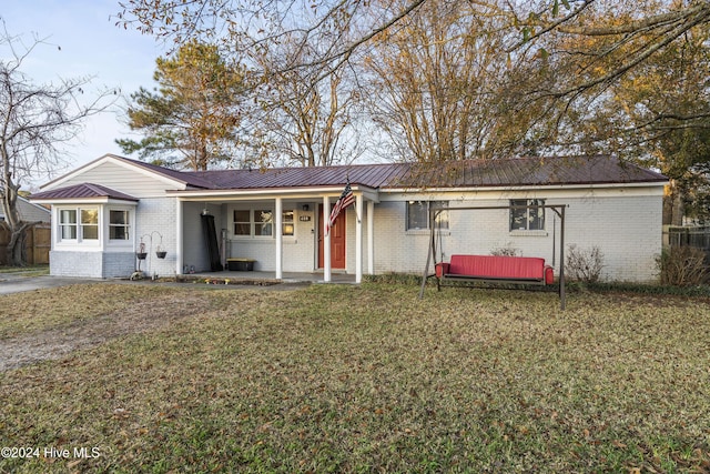 ranch-style house featuring a front lawn and covered porch