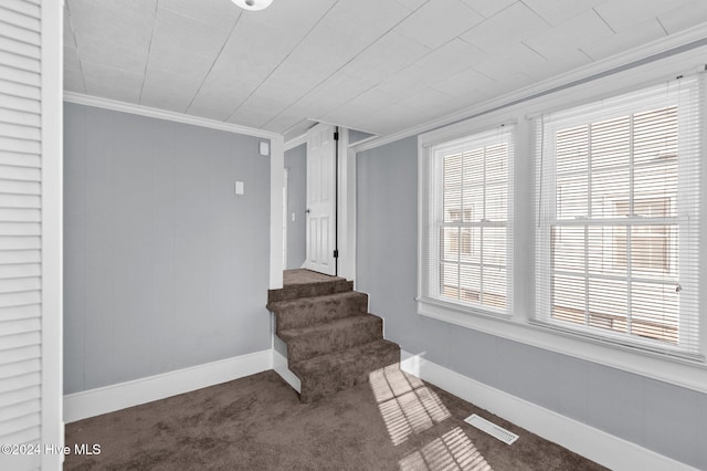 staircase with carpet floors and crown molding