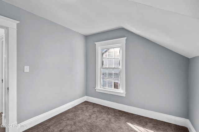 additional living space featuring carpet floors and vaulted ceiling