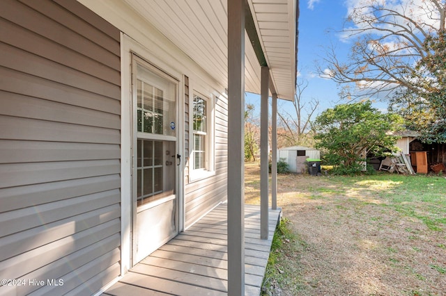 wooden deck featuring a storage unit