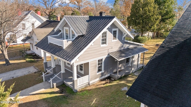 view of home's exterior featuring a balcony and a porch