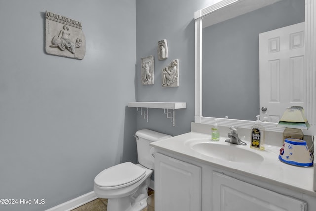 bathroom with tile patterned floors, vanity, and toilet