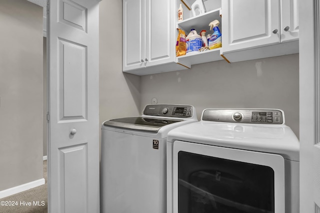 washroom featuring washer and dryer, carpet floors, and cabinets