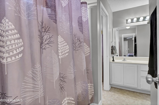 bathroom with vanity and a textured ceiling